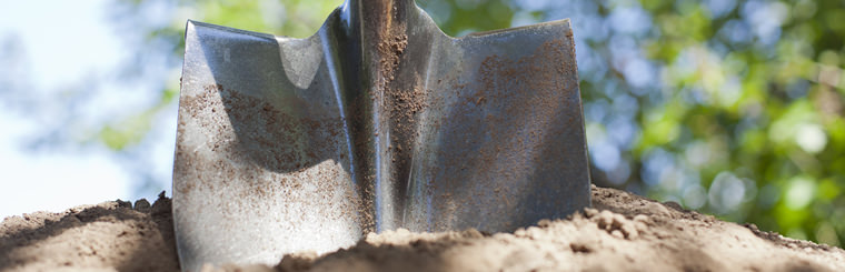 Shovel digging in dirt