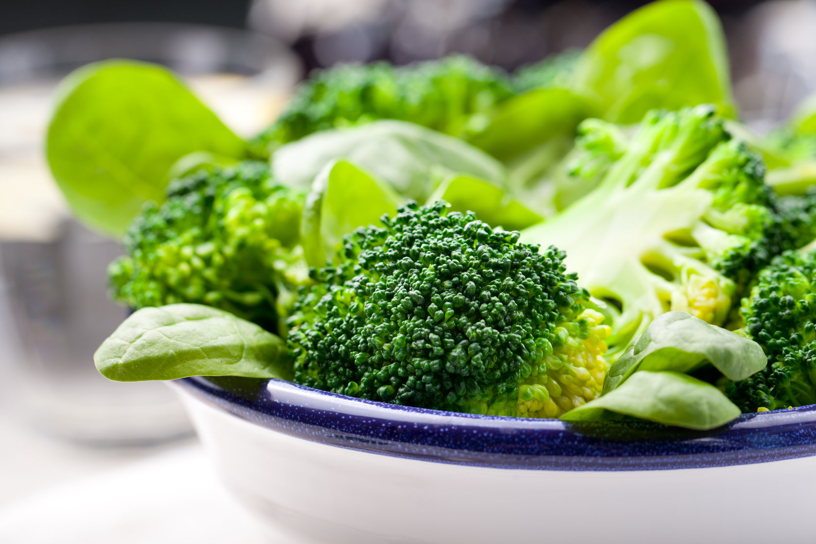 Raw broccoli and spinach in a bowl