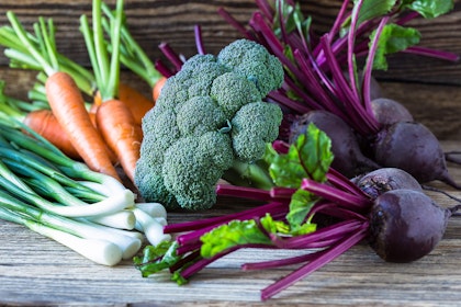 a variety of winter vegetables on a wooden table