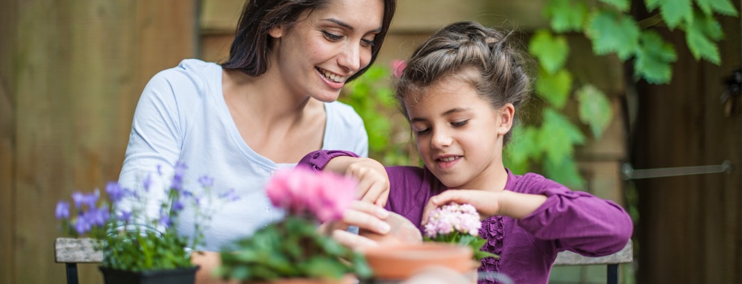 Woman and young girl gardening