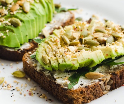 Two pieces of avocado toast on a plate