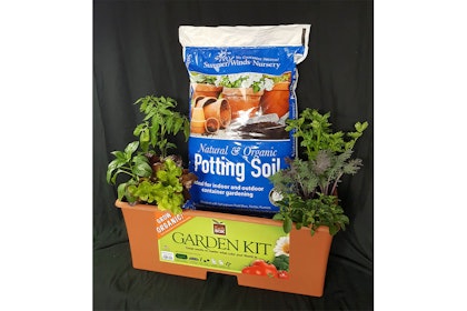 EarthBox Gardening Kit display with with SummerWinds' Potting Soil and some plants placed inside it