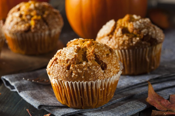 pumpkin muffins with pumpkins in the background