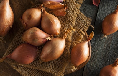 Yellow shallots edible bulbs yellow shallots on burlap on table