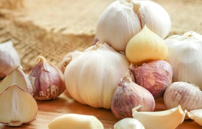 Assorted garlic bulbs grown from edible bulbs Assorted garlic bulbs piled on top of each other