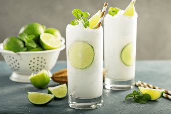 Minto Mojito Slushie with limes in a collander