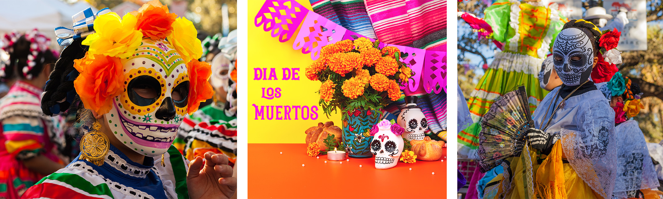 A woman, and a child dressed up for dia de los muertos, and traditional dia de los muertos decor (skulls, marigolds, flags, candles, blanket, and food.