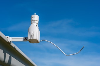 A rain sensor on a roof gutter.