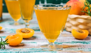 blenheim apricot liqueur in glasses on table with fresh apricots