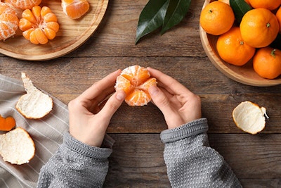 person peeling mandarin oranges summerwinds arizona