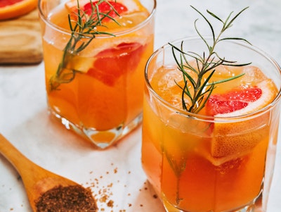 grapefruit rosemary spritzer mocktail drink with citrus garnished with rosemary