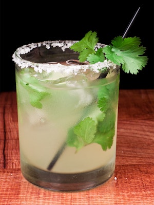 A cilantro margarita on a table.