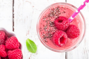 raspberry smoothie garnished with raspberries and chia seeds