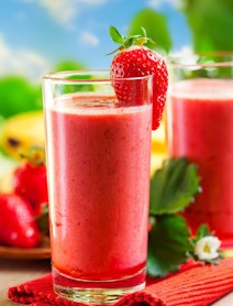 strawberry smoothie garnished with a strawberry