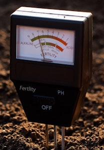 soil tester with soil in the background