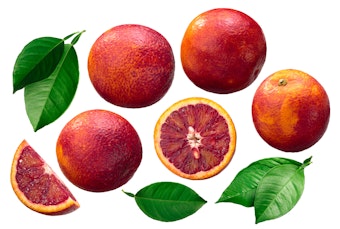 Blood oranges - whole, sliced and their leaves.