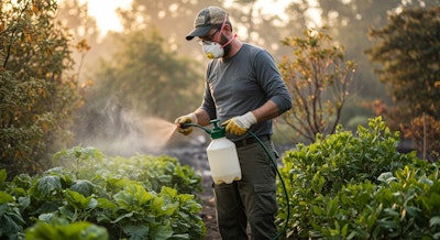 man in protective wear, cleaning up his yard after nearby wildfire