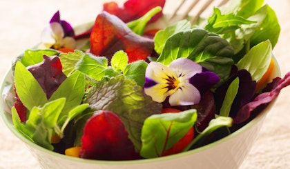 salad with edible pansy flowers
