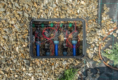 A drip irrigation box in the ground.