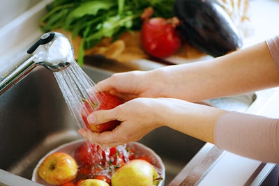 washing fruit in sink with bucket collecting water summerwinds california