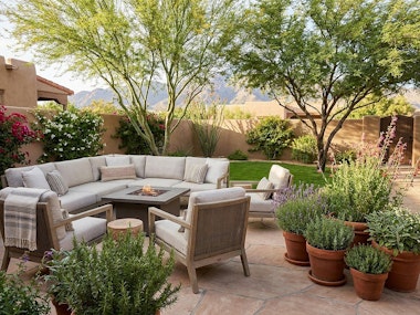 A backyard in the Southwest with comfortable seating, potted herbs, flowering vines, a small lawn,