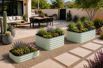 A Southwest backyard with seating and dining areas, potted and desert-friendly plants, and three different sizes of metal raised garden beds.