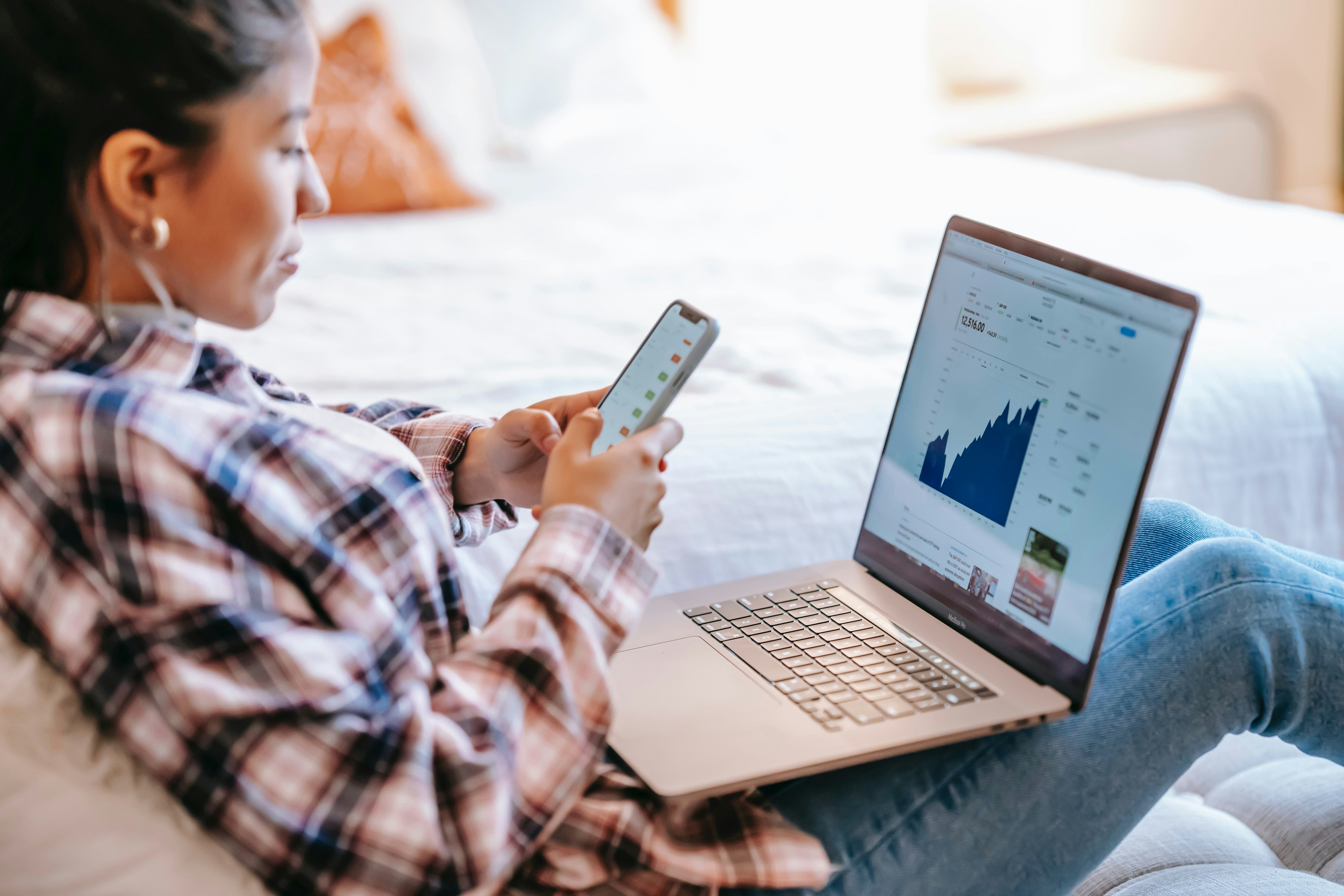 Woman looking at stocks on her phone