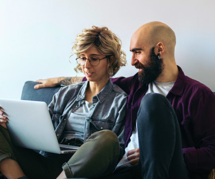 Man and woman looking at a laptop