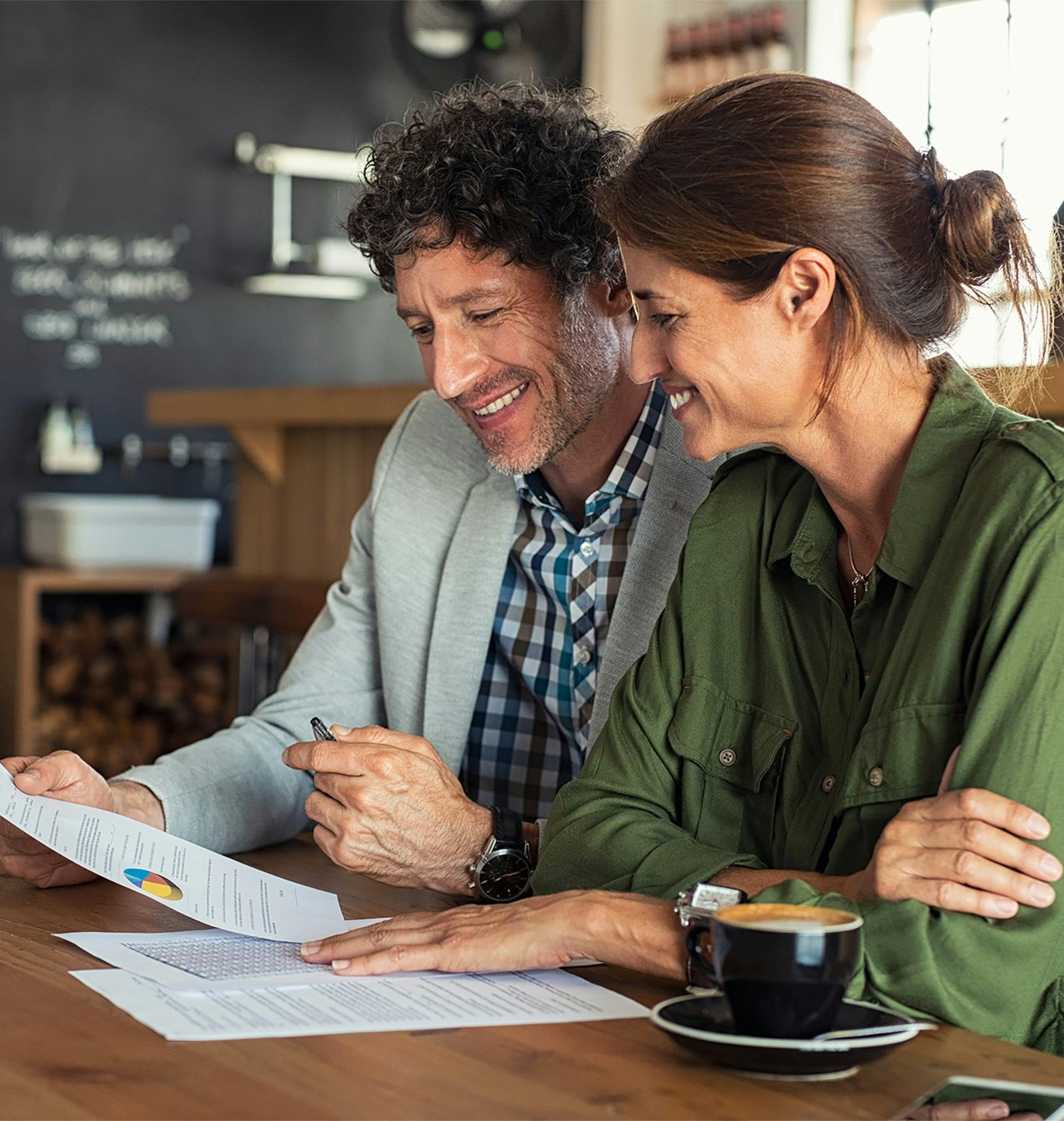 Businessman and businesswoman signing a document