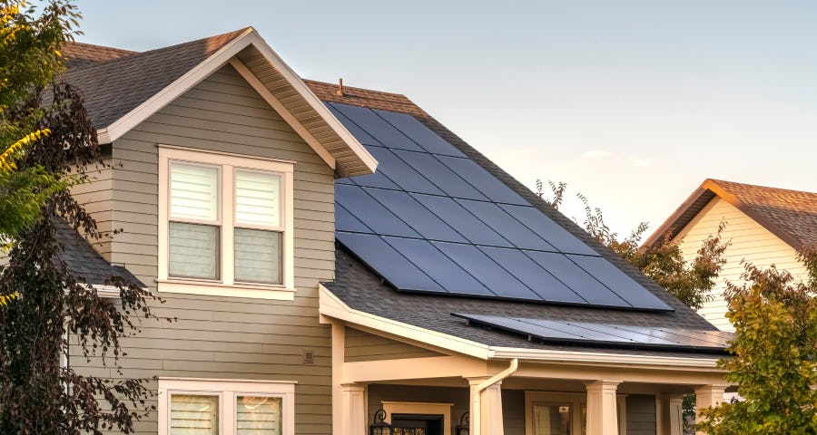 Image of the outside of a home with solar panels