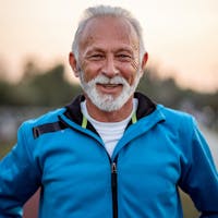 Middle aged man wearing a outfit to workout in, smiling.