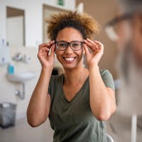 Woman trying on glasses to help with her nearsightedness in Beverly Hills.