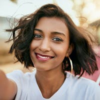 Woman smiling after receiving Astigmatism treatment in Beverly Hills.