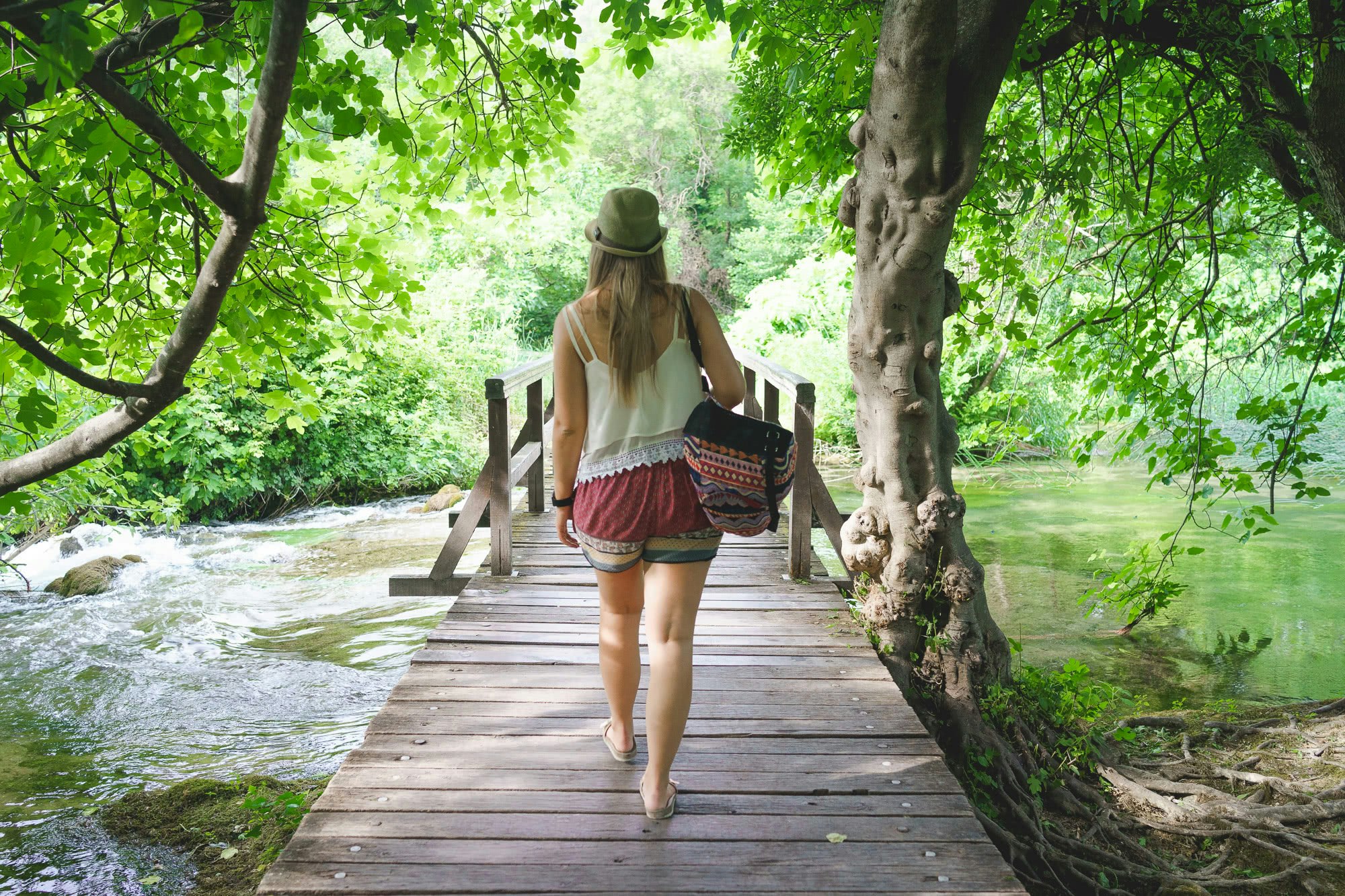 Ina walking on the boardwalk through the trees