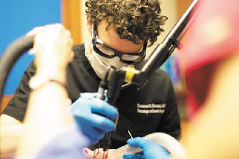 Dr Chestnut performing surgery on client