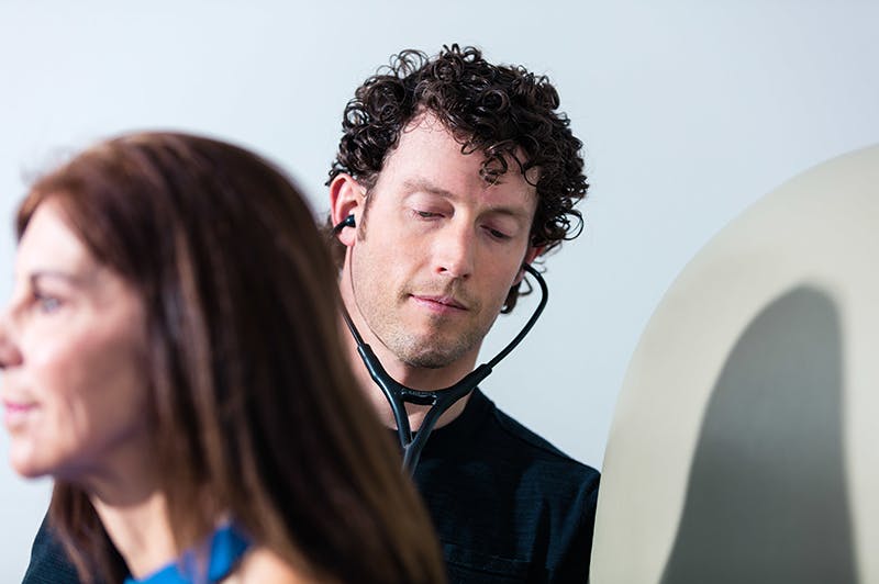 Dr. Chesnut checking client's heart beat