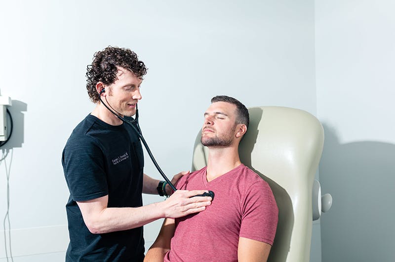 Dr. Chestnut checking client's heartbeat