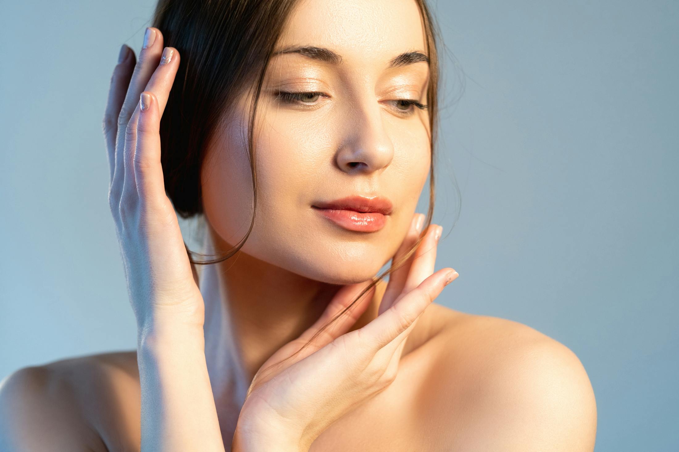 model with her hands framing her face
