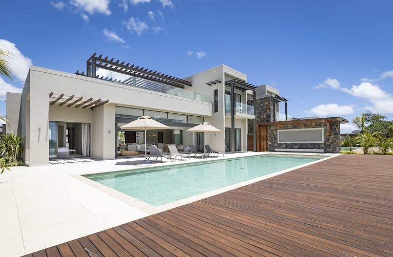 house housing villa chair deck porch water waterfront pool person