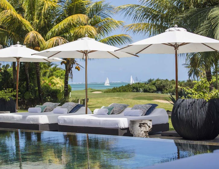 building housing patio patio umbrella canopy pool swimming pool grass outdoors bed