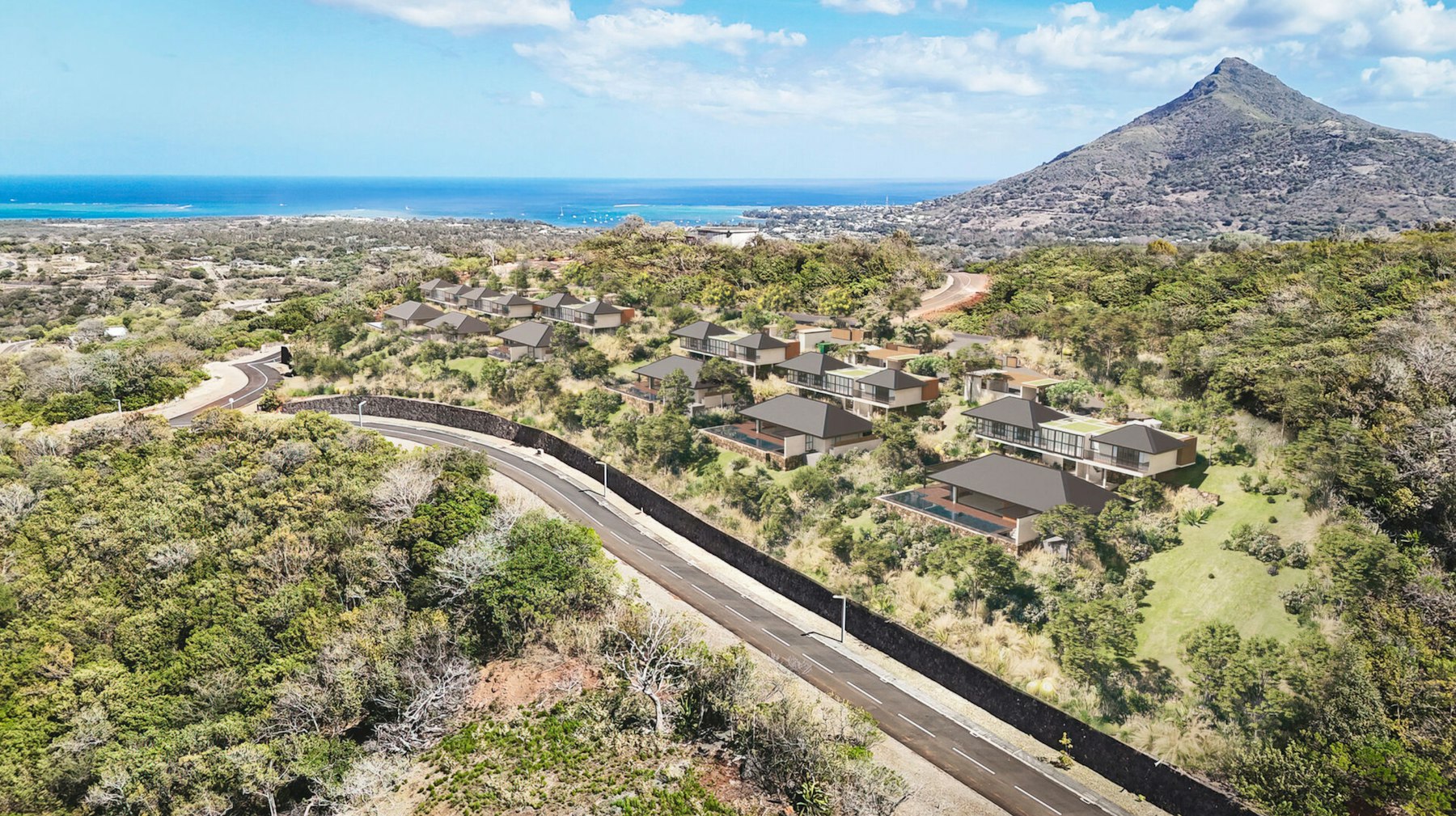 The six Peak Panorama villas on the Domaine de Palmyre hillside, ocean beyond