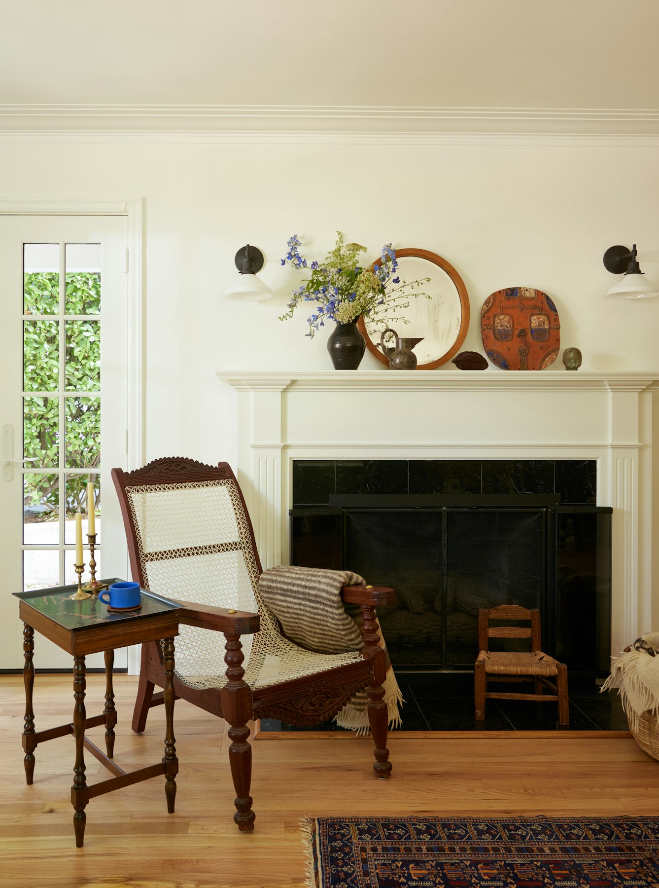 livingroom showing fireplace with african chair and art