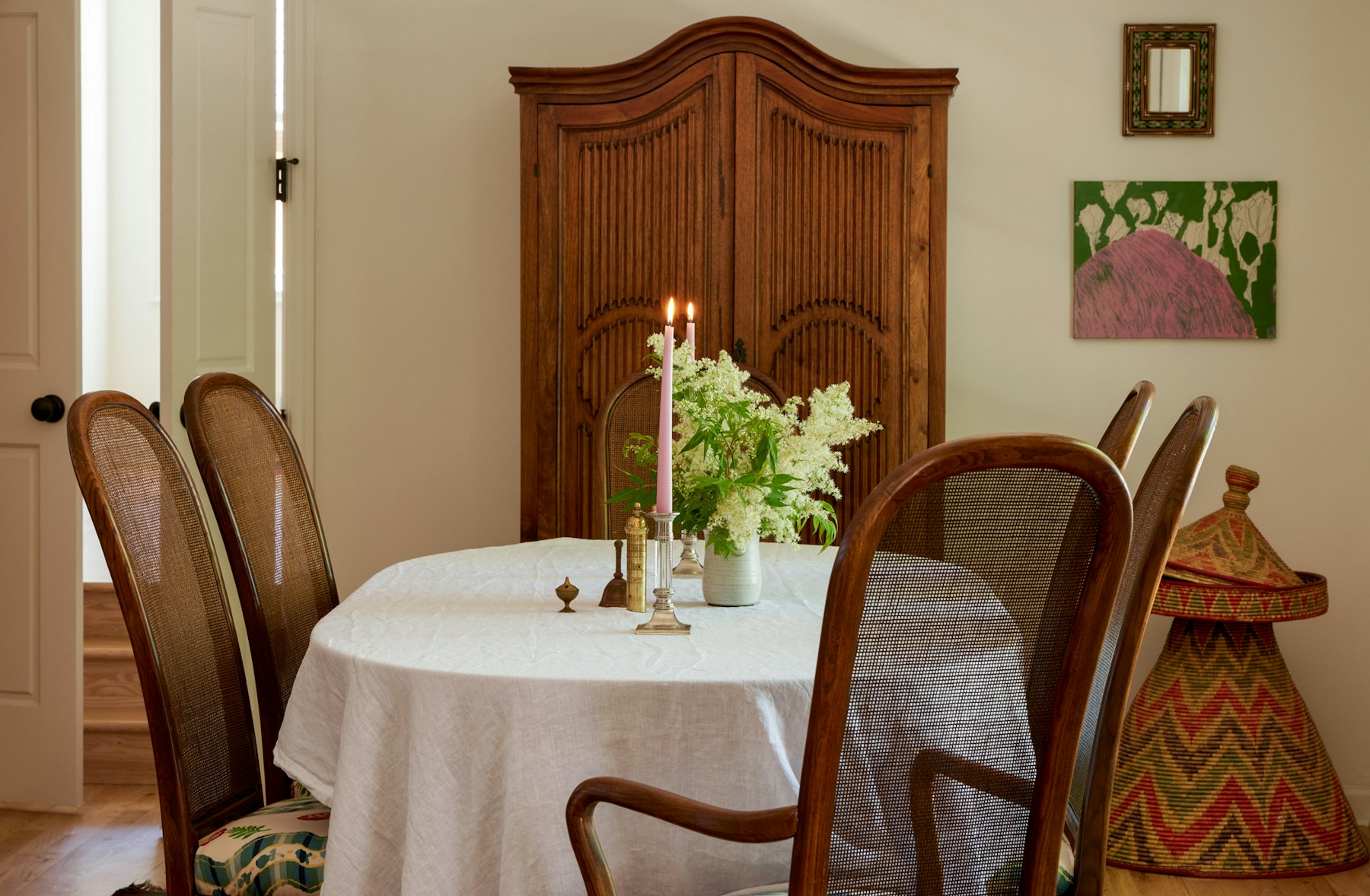 vintage cane chairs around oval table with linen tablecloth