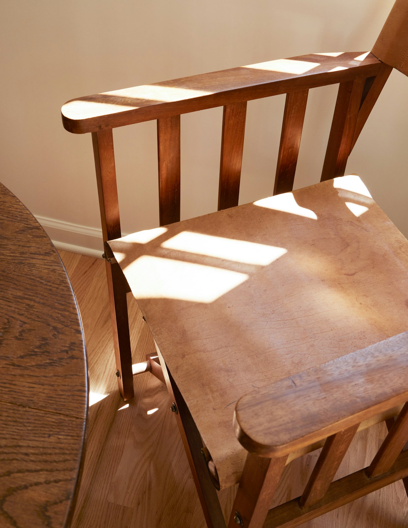 leather and wood chair with sunlight pattern 