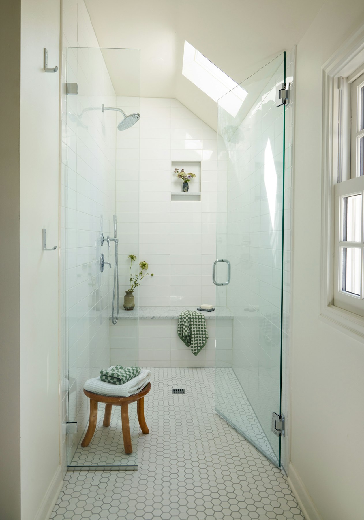 walk in shower with built in bench and skylight 