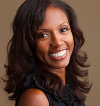 Smiling woman with dark hair.