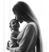 Black and white photo of a woman holding her baby.