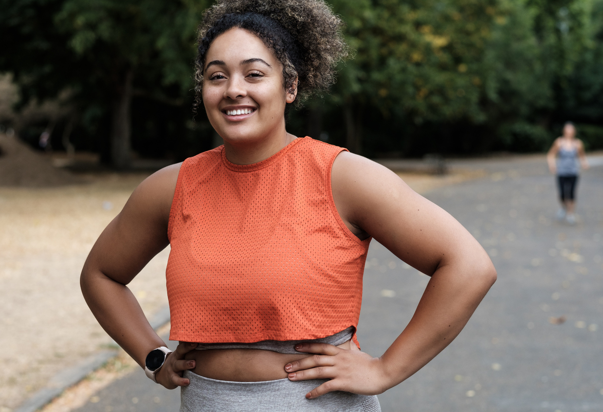 Woman in orange tank top jogging