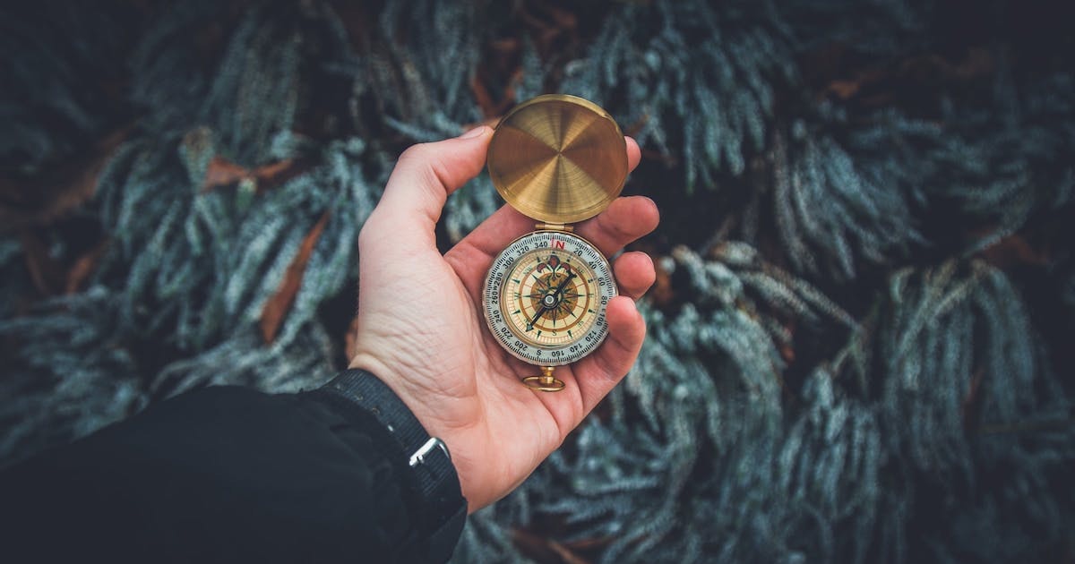 hand holding a compass