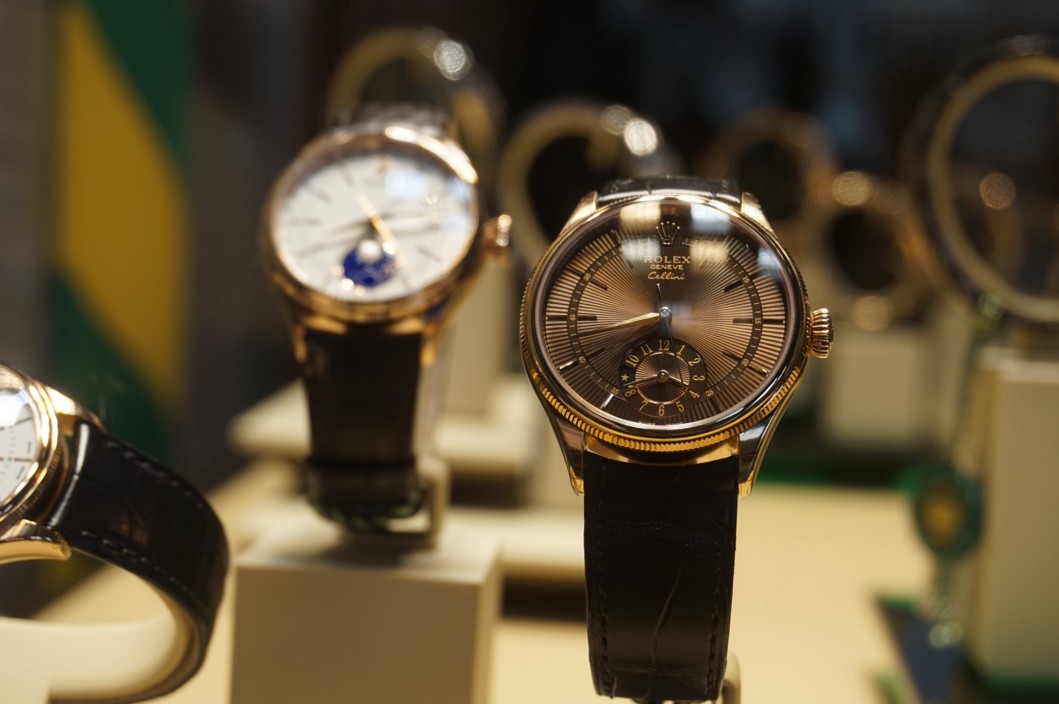 Rolex and other luxury watches in a shop window.